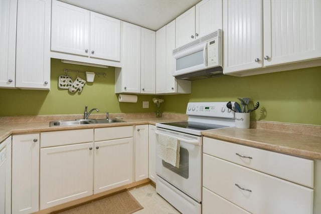 145 Milk St Unit 10, Westborough, MA 01581 - kitchen featuring white appliances, white cabinetry, and light countertops