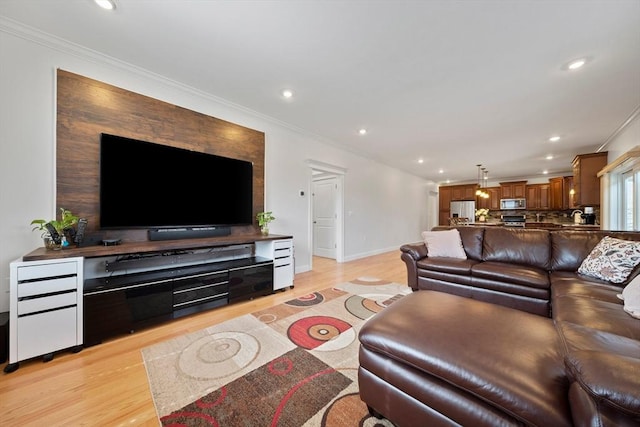 living room featuring crown molding, recessed lighting, and light wood-style floors