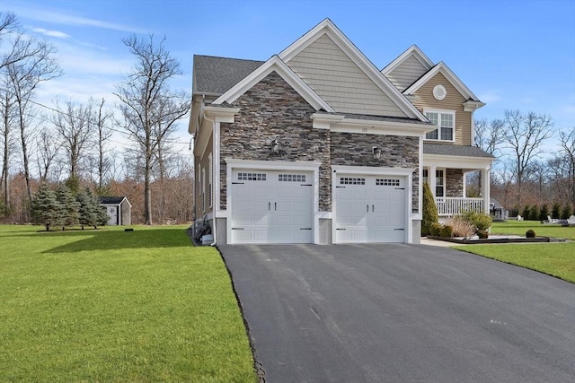 view of front of home with an attached garage, a front lawn, a porch, stone siding, and driveway