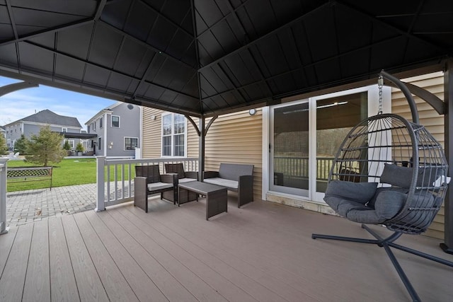 wooden terrace featuring a gazebo, a yard, and an outdoor living space