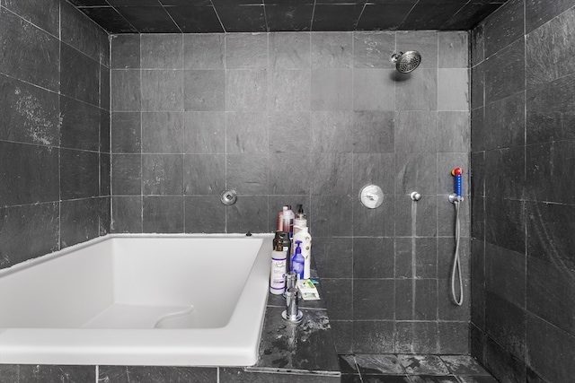 bathroom featuring tile walls and tiled shower