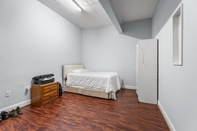 bedroom with dark hardwood / wood-style flooring