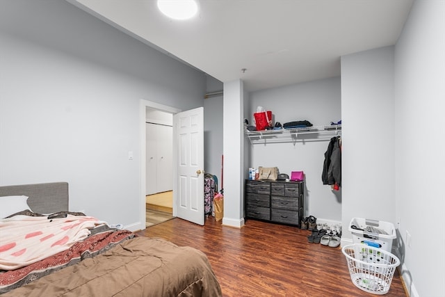 bedroom featuring dark wood-type flooring and a closet