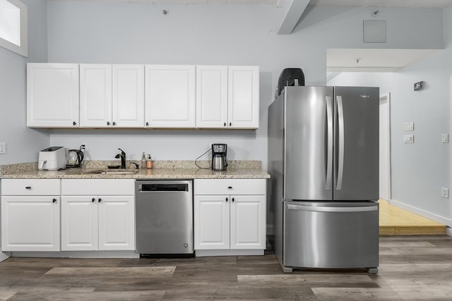 kitchen with white cabinetry, appliances with stainless steel finishes, sink, and dark hardwood / wood-style floors