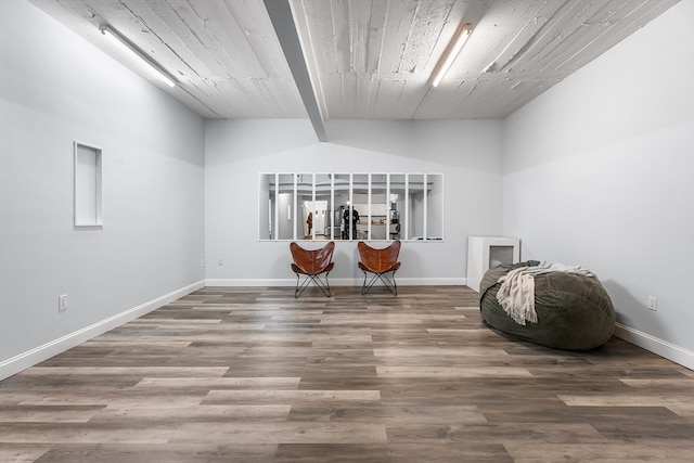 interior space with hardwood / wood-style floors and vaulted ceiling with beams