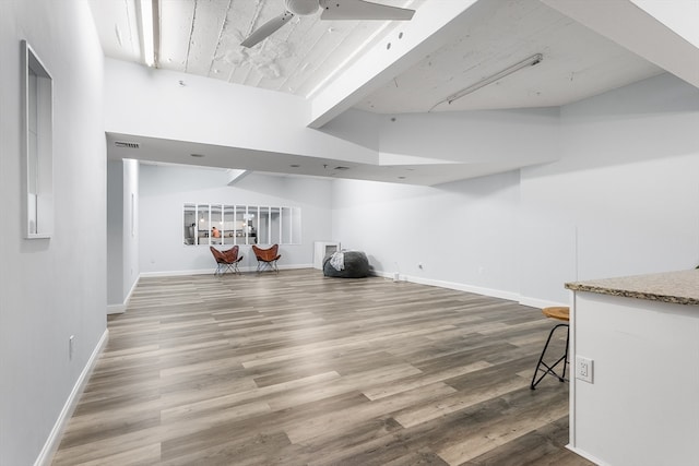 basement featuring ceiling fan and wood-type flooring