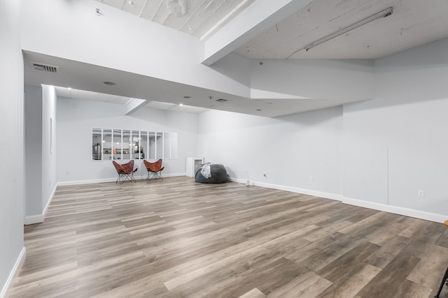 basement with light hardwood / wood-style flooring