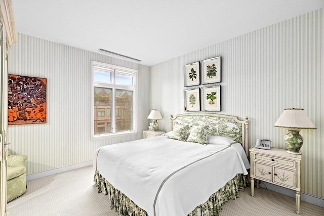 bedroom featuring visible vents, baseboards, carpet, and wallpapered walls