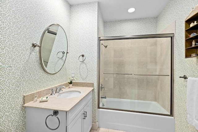 bathroom featuring vanity and bath / shower combo with glass door