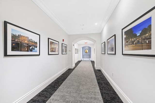 hall with crown molding, dark carpet, arched walkways, recessed lighting, and baseboards