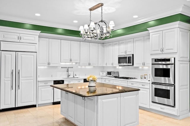 kitchen featuring an inviting chandelier, white cabinetry, a kitchen island, appliances with stainless steel finishes, and a sink