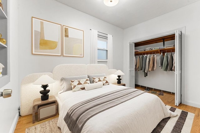 bedroom featuring a closet, baseboards, and wood finished floors