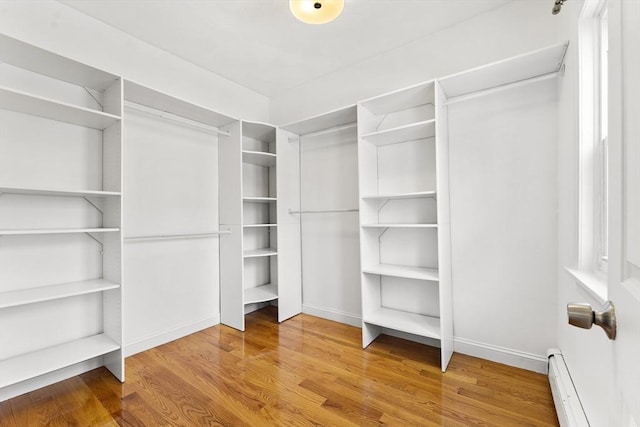 walk in closet featuring a baseboard radiator and wood-type flooring