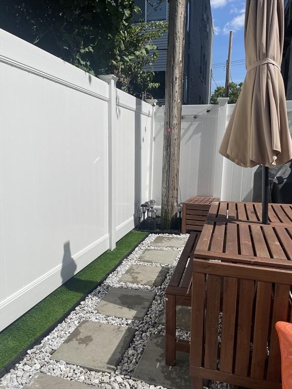 view of patio / terrace featuring fence