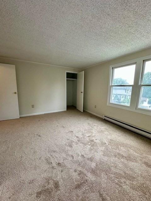270 Sunderland St Unit 77, Worcester, MA 01604 - spare room featuring light colored carpet, a baseboard radiator, a textured ceiling, and baseboards