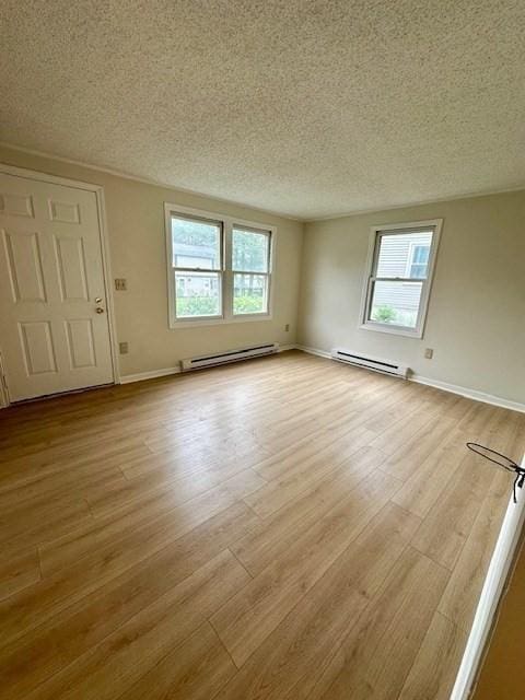 270 Sunderland St Unit 77, Worcester, MA 01604 - unfurnished living room featuring a baseboard radiator, a textured ceiling, plenty of natural light, and light wood-type flooring