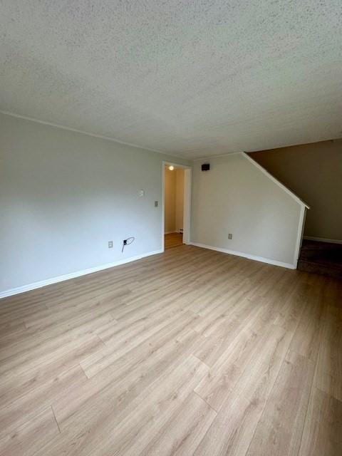 270 Sunderland St Unit 77, Worcester, MA 01604 - unfurnished living room featuring a textured ceiling, light wood-type flooring, and baseboards