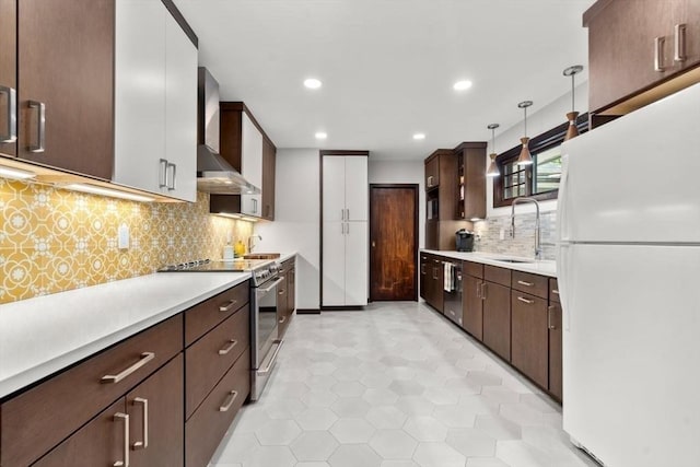 119 S Main St, Sharon, MA 02067 - kitchen with stainless steel appliances, wall chimney range hood, light countertops, a sink, and backsplash
