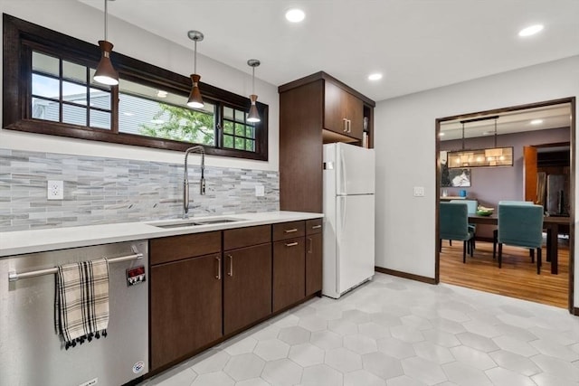 119 S Main St, Sharon, MA 02067 - kitchen featuring freestanding refrigerator, stainless steel dishwasher, a sink, light countertops, and dark brown cabinets