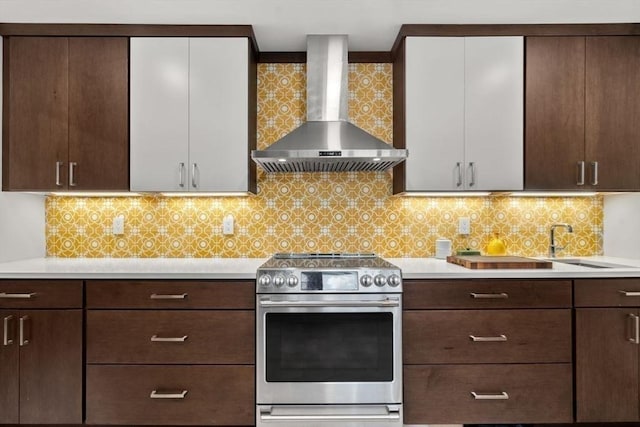 119 S Main St, Sharon, MA 02067 - kitchen featuring wall chimney exhaust hood, stainless steel electric stove, light countertops, and dark brown cabinets