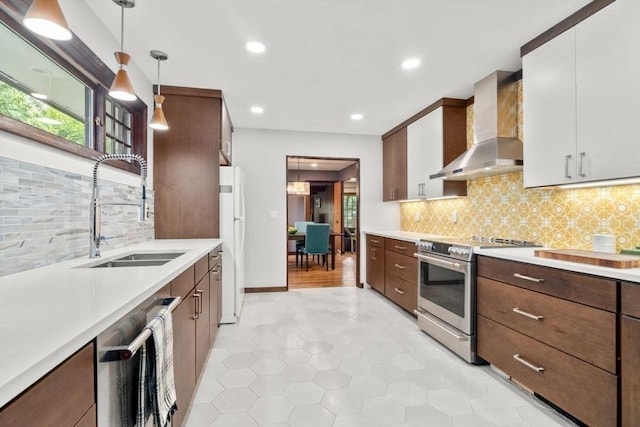 119 S Main St, Sharon, MA 02067 - kitchen featuring wall chimney range hood, stainless steel appliances, a sink, light countertops, and recessed lighting