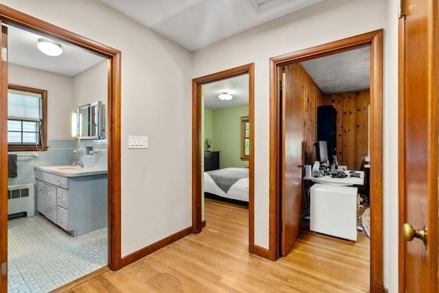 119 S Main St, Sharon, MA 02067 - hallway featuring radiator, light wood-style flooring, baseboards, and a sink
