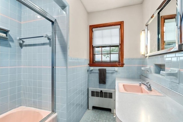119 S Main St, Sharon, MA 02067 - bathroom with radiator, tile walls, combined bath / shower with glass door, vanity, and a wainscoted wall