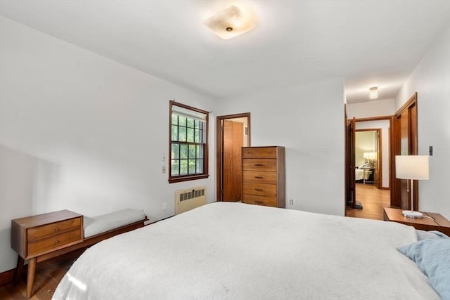 119 S Main St, Sharon, MA 02067 - bedroom featuring radiator heating unit and dark wood-style flooring