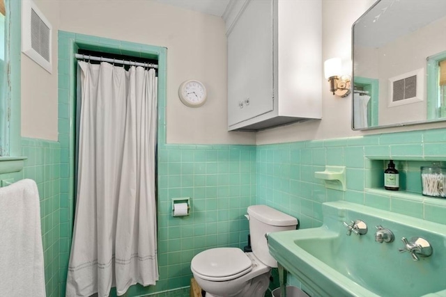 119 S Main St, Sharon, MA 02067 - bathroom featuring tile walls, a wainscoted wall, toilet, a sink, and curtained shower