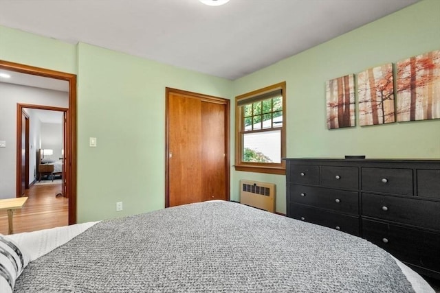 119 S Main St, Sharon, MA 02067 - bedroom with radiator heating unit, a closet, and wood finished floors