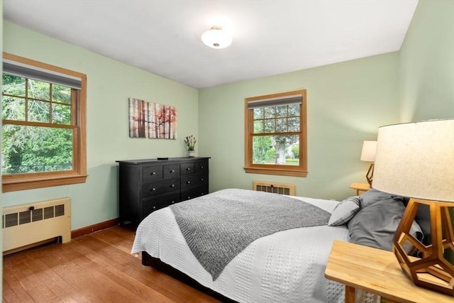 119 S Main St, Sharon, MA 02067 - bedroom featuring radiator, wood finished floors, multiple windows, and baseboards