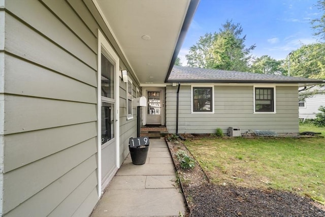 119 S Main St, Sharon, MA 02067 - view of exterior entry with a yard and roof with shingles