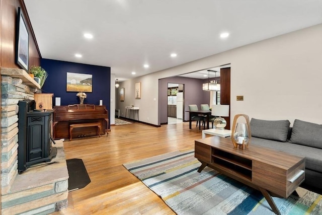 119 S Main St, Sharon, MA 02067 - living area with light wood-type flooring, recessed lighting, and a wood stove