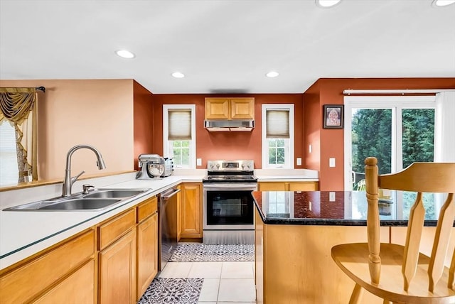 kitchen featuring light tile patterned floors, extractor fan, appliances with stainless steel finishes, a breakfast bar, and sink