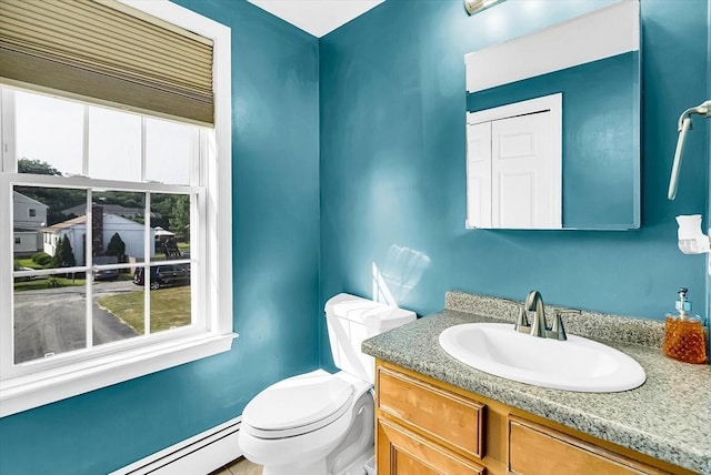 bathroom featuring toilet, vanity, and a baseboard radiator