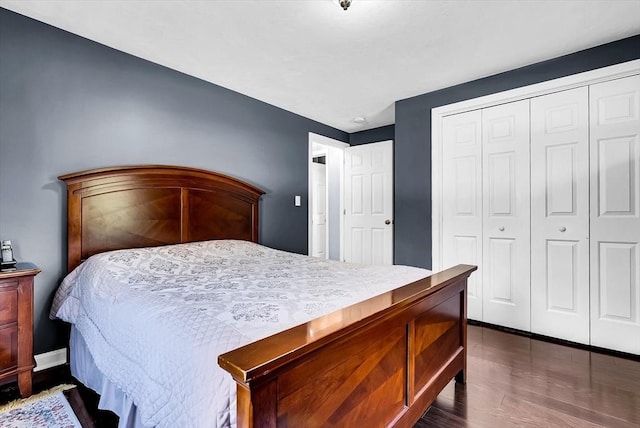 bedroom with a closet and dark hardwood / wood-style floors