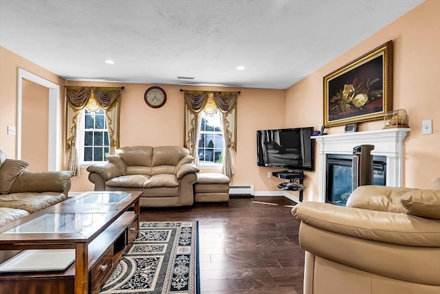 living room with a baseboard radiator, a wealth of natural light, and dark hardwood / wood-style floors