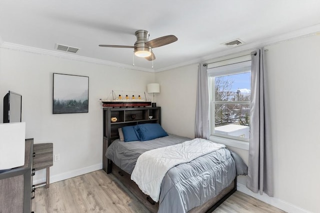 bedroom featuring ceiling fan, ornamental molding, and light hardwood / wood-style floors