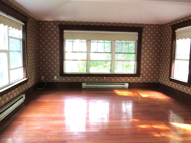 187 High St, Billerica, MA 01862 - empty room featuring baseboard heating, wallpapered walls, baseboards, and wood finished floors