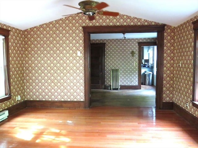 187 High St, Billerica, MA 01862 - spare room with wallpapered walls, wood finished floors, lofted ceiling, ceiling fan, and baseboards
