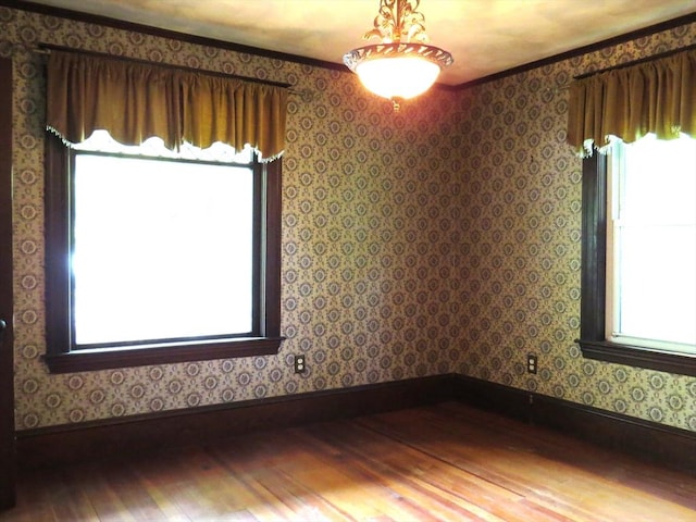187 High St, Billerica, MA 01862 - unfurnished room with hardwood / wood-style floors, baseboards, wallpapered walls, and ornamental molding