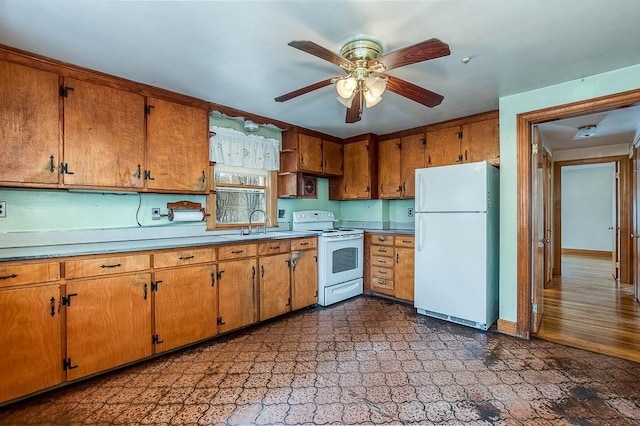 1049 Pleasant St, Canton, MA 02021 - kitchen with dark floors, ceiling fan, brown cabinetry, and white appliances