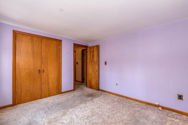 1049 Pleasant St, Canton, MA 02021 - unfurnished bedroom featuring baseboards, carpet flooring, and a closet
