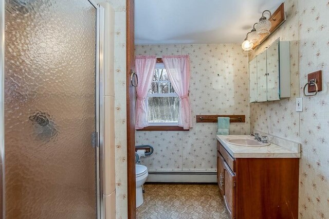 1049 Pleasant St, Canton, MA 02021 - full bathroom featuring baseboard heating, vanity, toilet, wallpapered walls, and a stall shower