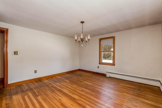 1049 Pleasant St, Canton, MA 02021 - spare room with an inviting chandelier, baseboards, a baseboard heating unit, and wood finished floors