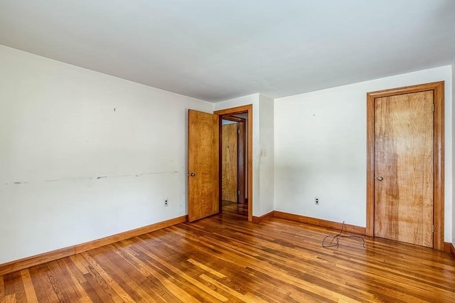 1049 Pleasant St, Canton, MA 02021 - spare room featuring baseboards and wood finished floors