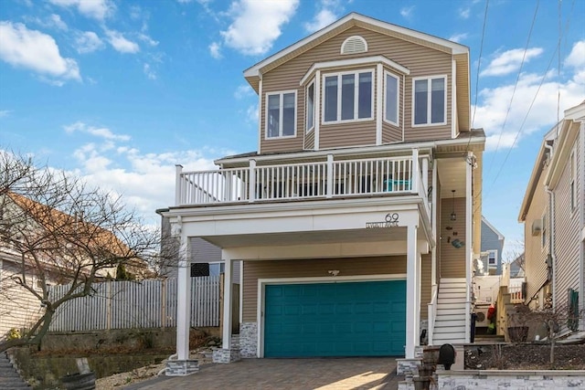 69 Leverett Ave, Revere, MA 02151 - view of front of property featuring a balcony, a garage, decorative driveway, and a carport