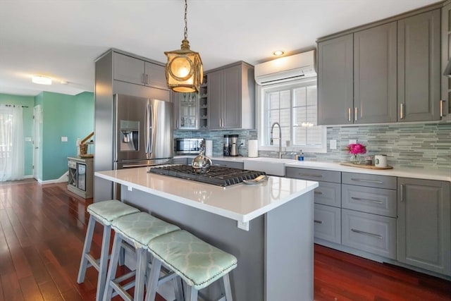 69 Leverett Ave, Revere, MA 02151 - kitchen featuring gray cabinetry, a sink, appliances with stainless steel finishes, a kitchen bar, and recessed lighting
