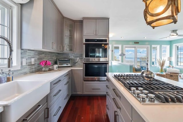 69 Leverett Ave, Revere, MA 02151 - kitchen with gray cabinetry, stainless steel appliances, a sink, and dark wood-type flooring