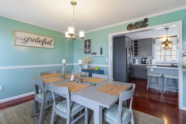 69 Leverett Ave, Revere, MA 02151 - dining area featuring crown molding, a chandelier, and dark wood-style flooring